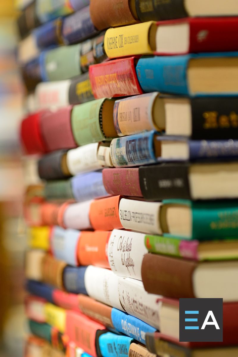 Several lined up stacks of books