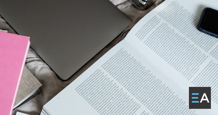 An open book on a cluttered desk