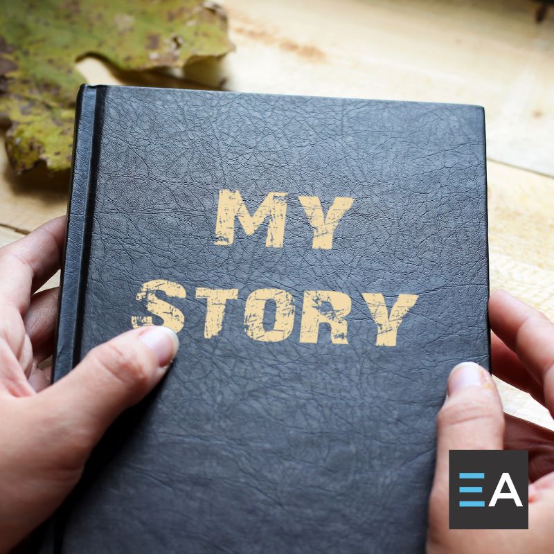 A person holding a book titled My Story