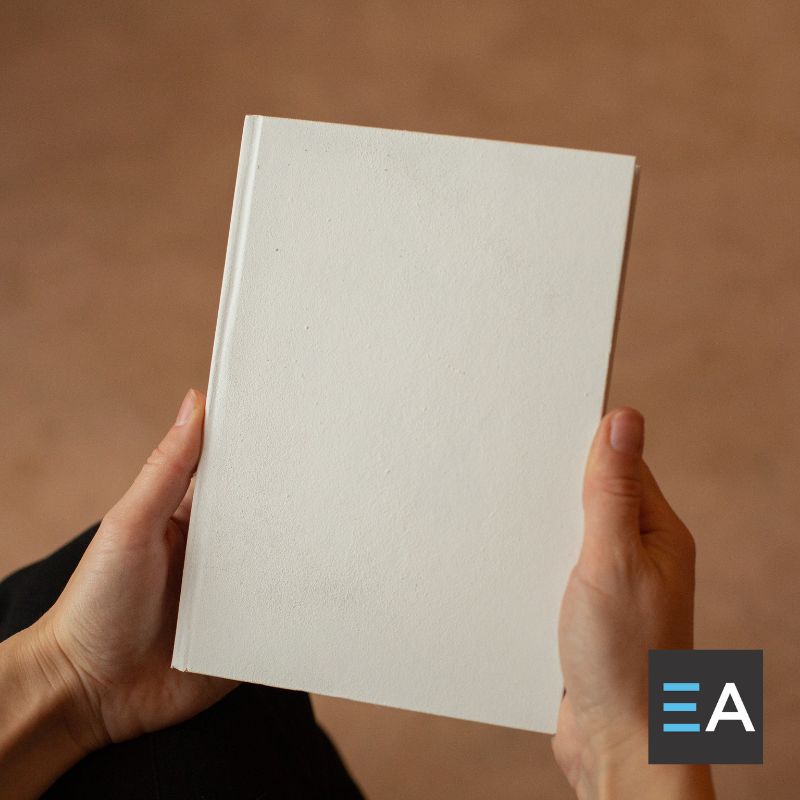 A person holding a blank book