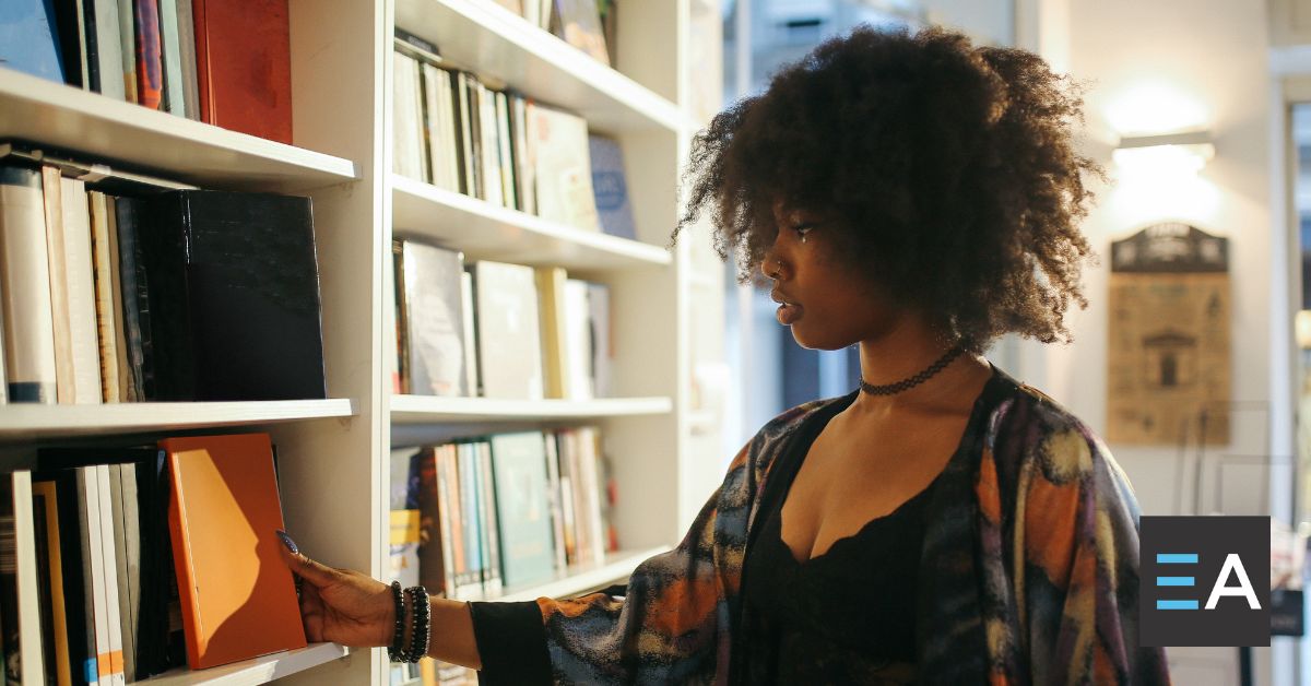 A person perusing a bookshelf