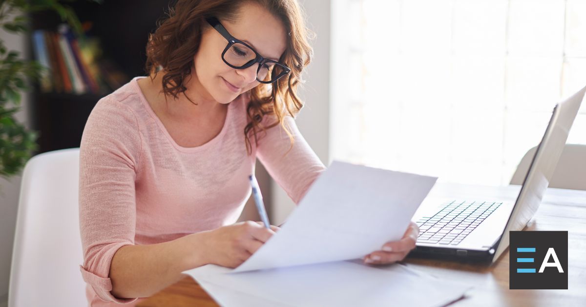 A person making notes on a piece of paper