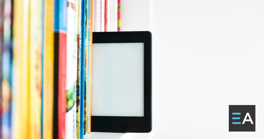 An e-reader on a shelf of books