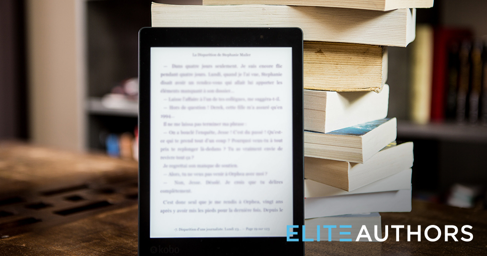 ebook in front of a stack of paperback books