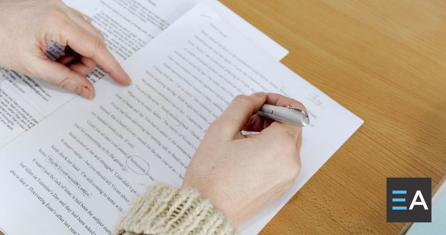 A person making notes on a manuscript