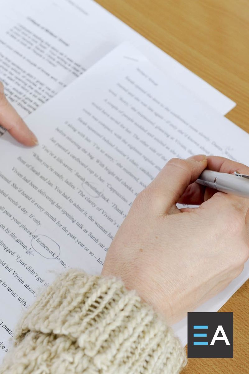 A person making notes on a manuscript