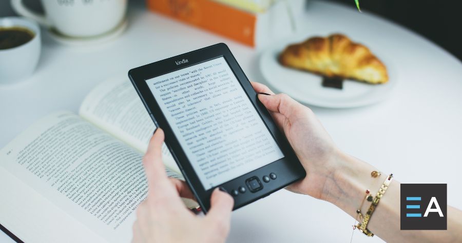 A person holding an e-reader displaying text