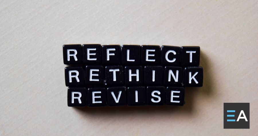 Black beads with white letters spelling out "reflect rethink revise"