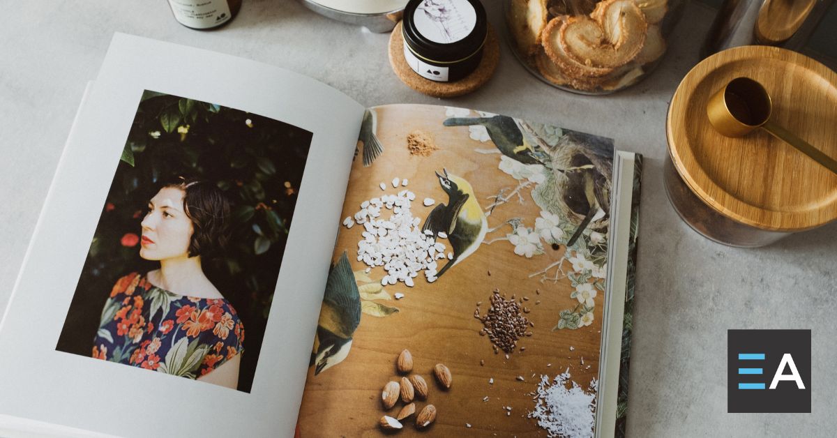 An open cookbook surrounded by spice jars