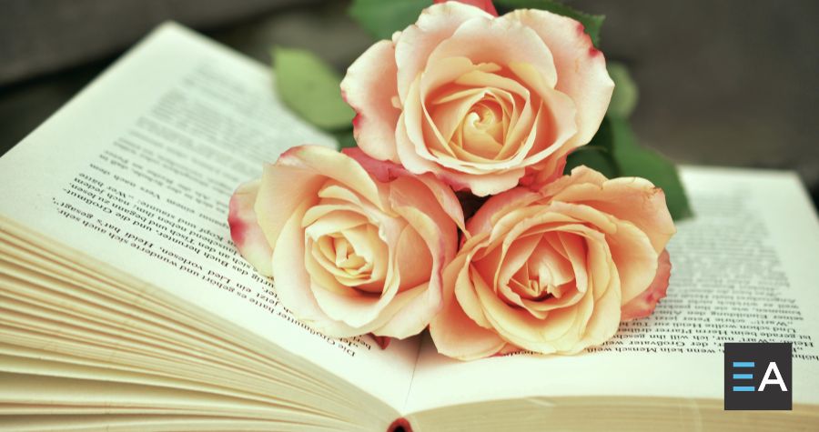 Three pink roses atop an open book