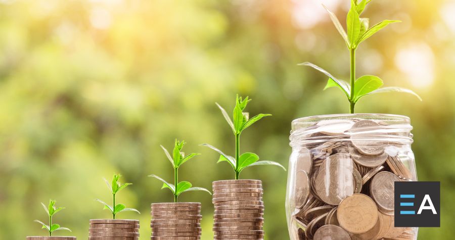 Plants sprouting from jars of coins