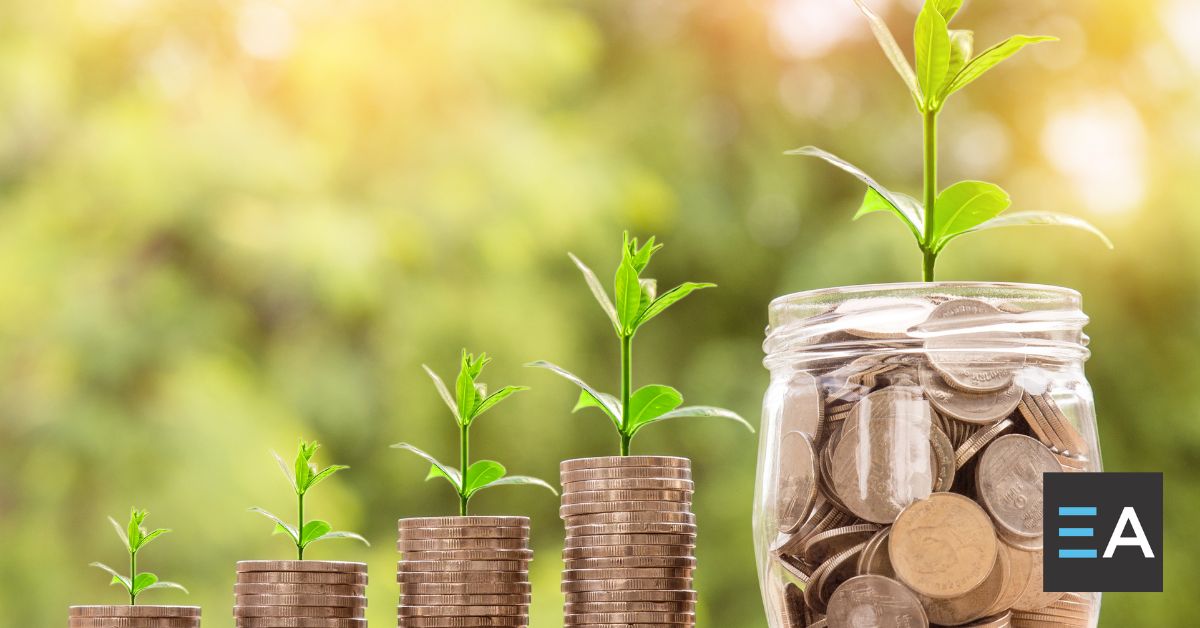 Plants sprouting from jars of coins