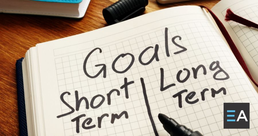 The words "Goals: Short Term | Long Term" written on graph paper