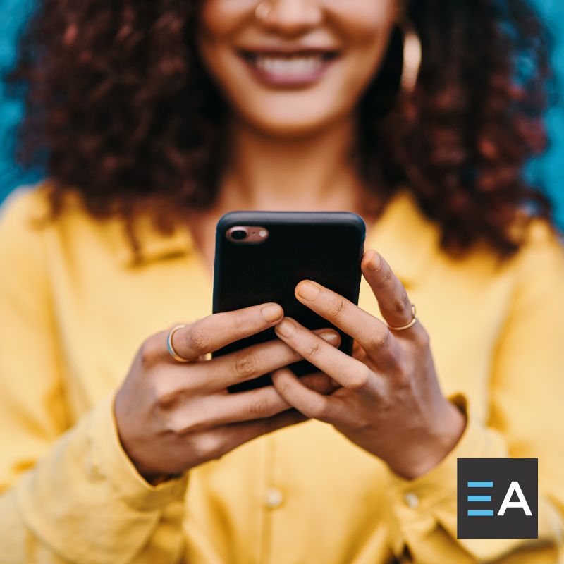 A person smiling at their smartphone