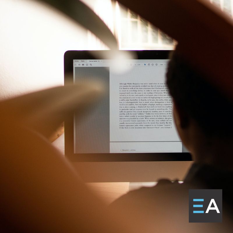 A person looking at a manuscript on a computer