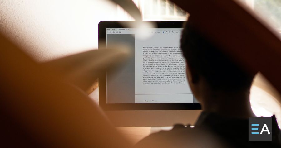 A person looking at a manuscript on a screen