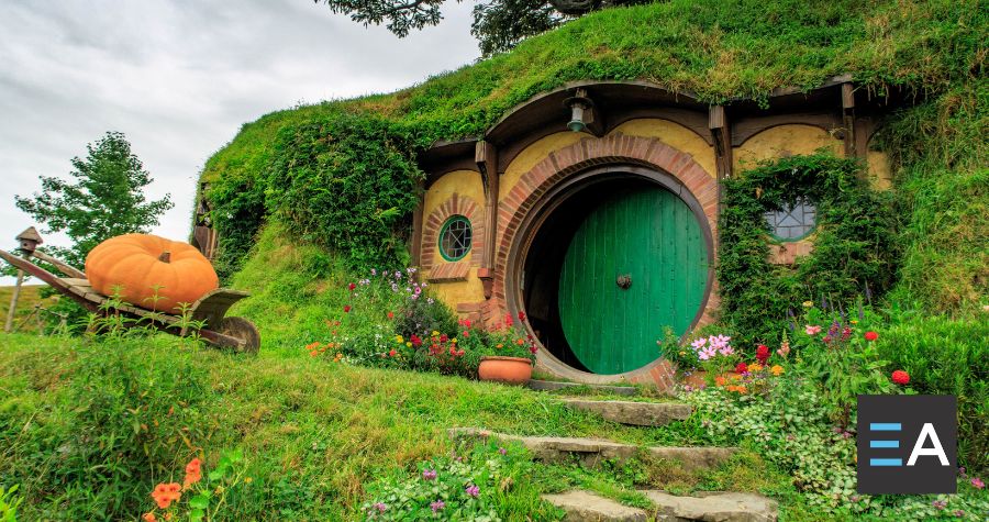 A circular hobbit door under a green hill