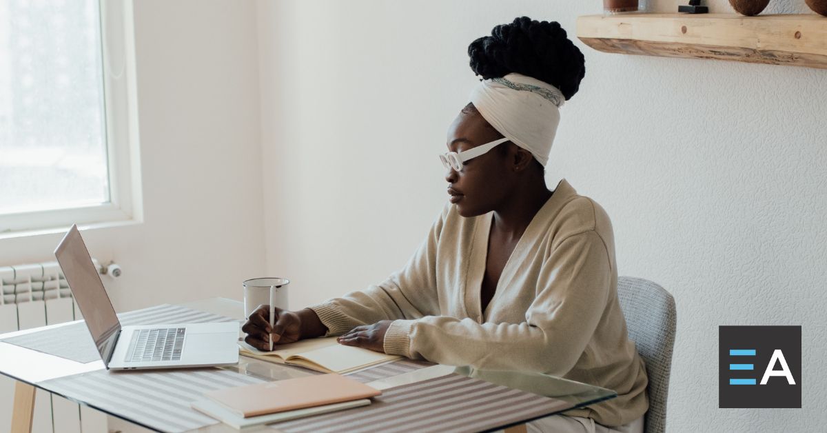 A person writing at a desk