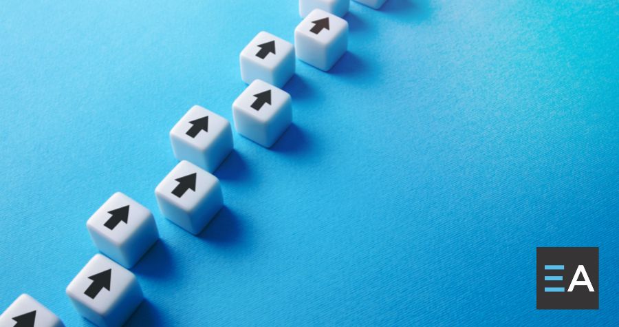 White cubes with black arrows on them lined up on a blue background