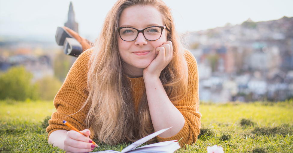 person outside with pen and paper