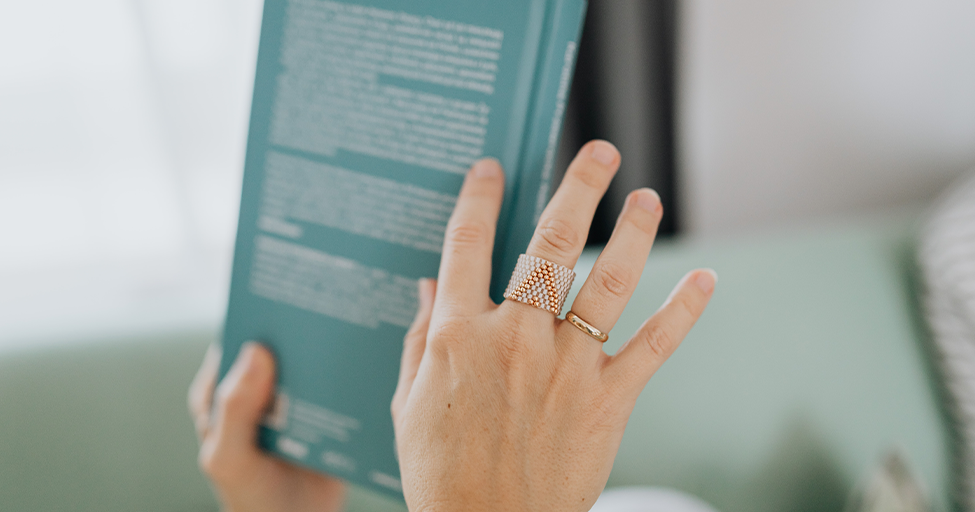 hand holding a book looking at the back cover