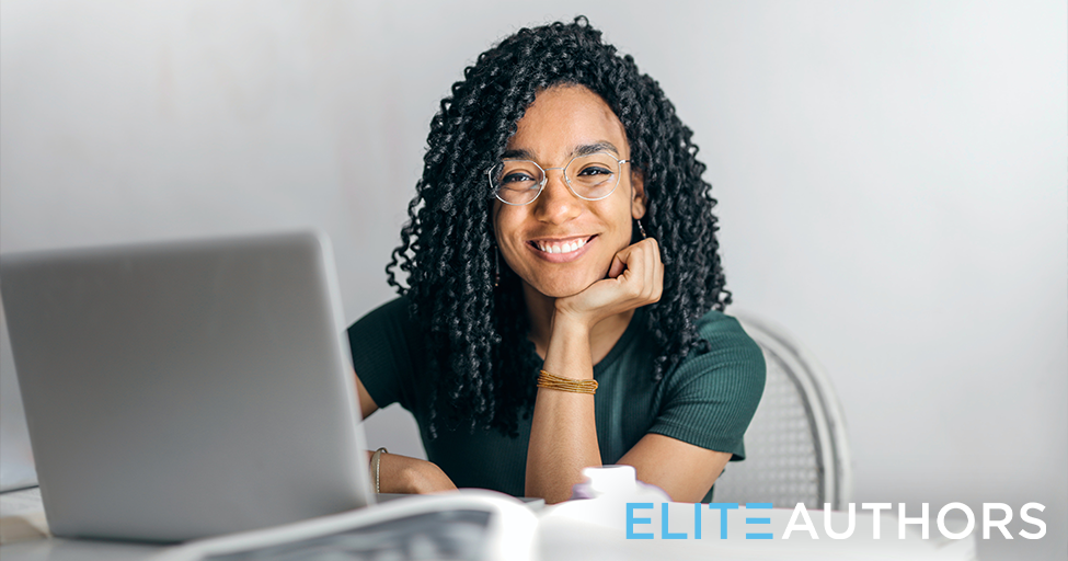 person smiling behind computer