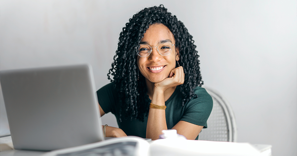 person smiling behind computer