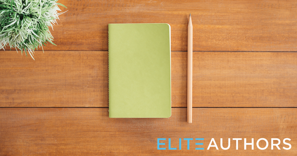 a green notebook and a pencil on a table