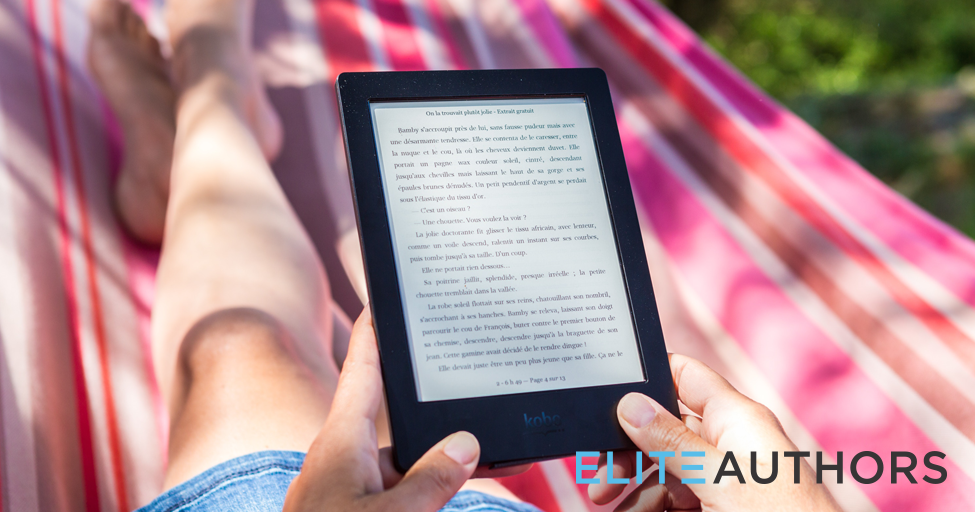 person reading an ebook outside on a picnic blanket