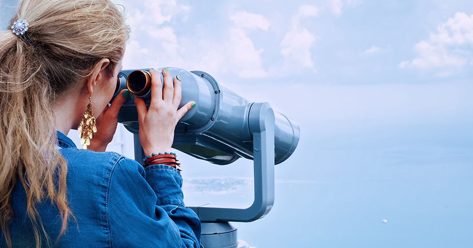 person looking through a telescope