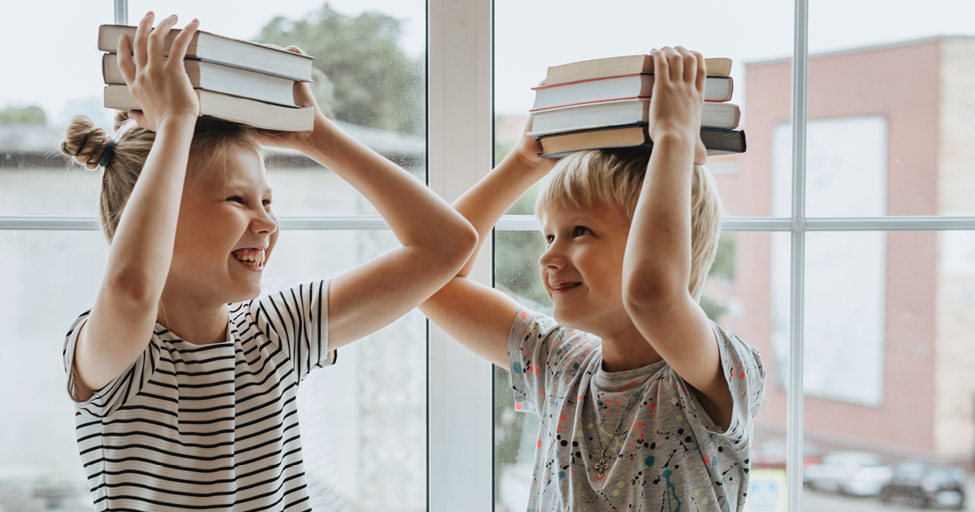 children with books on their heads