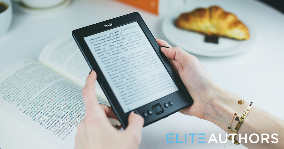 hands holding an e-book over a physical book